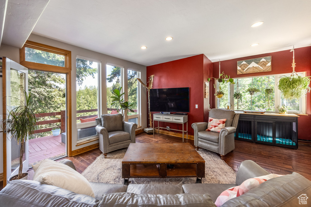 Living room with hardwood / wood-style flooring and recessed lighting