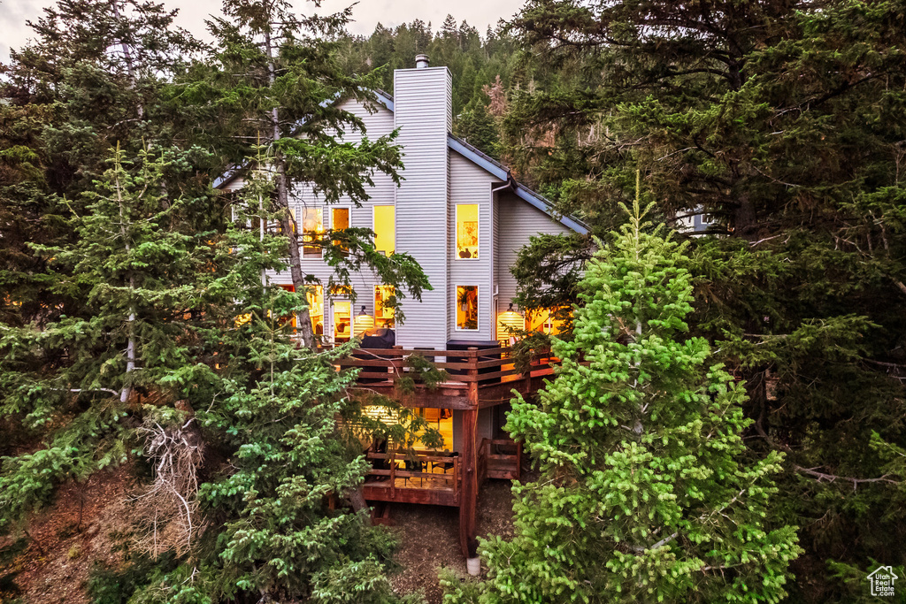 View of side of home with a wooden deck