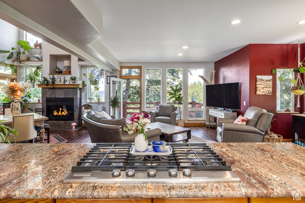 Living area featuring a tile fireplace, hardwood / wood-style floors, and recessed lighting
