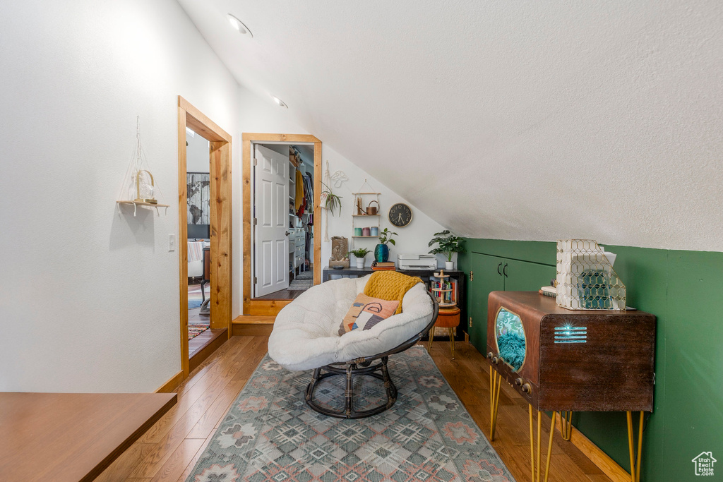 Living area featuring lofted ceiling and light wood-style flooring