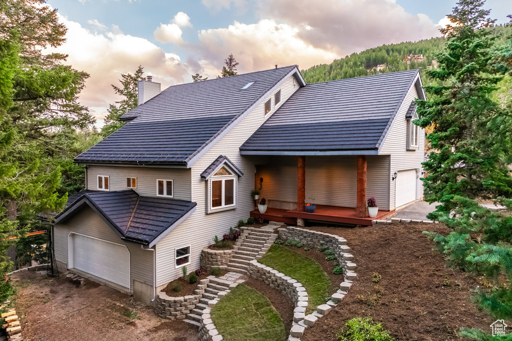 Back house at dusk with a wooden deck