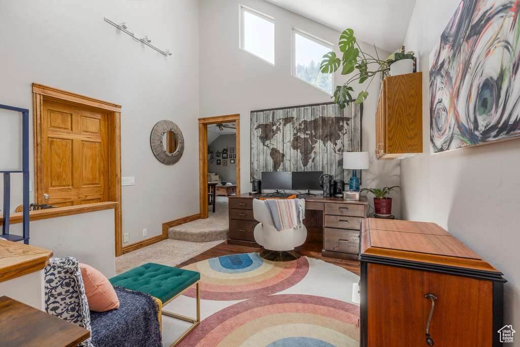 Home office with baseboards and a high ceiling