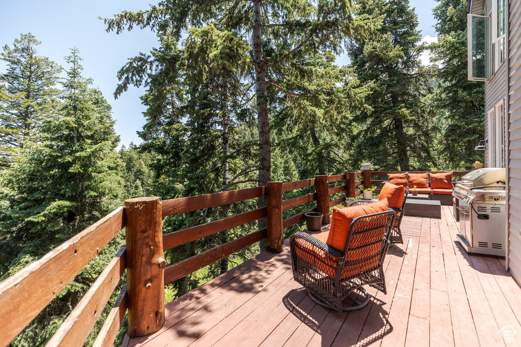 Deck featuring an outdoor hangout area and a grill