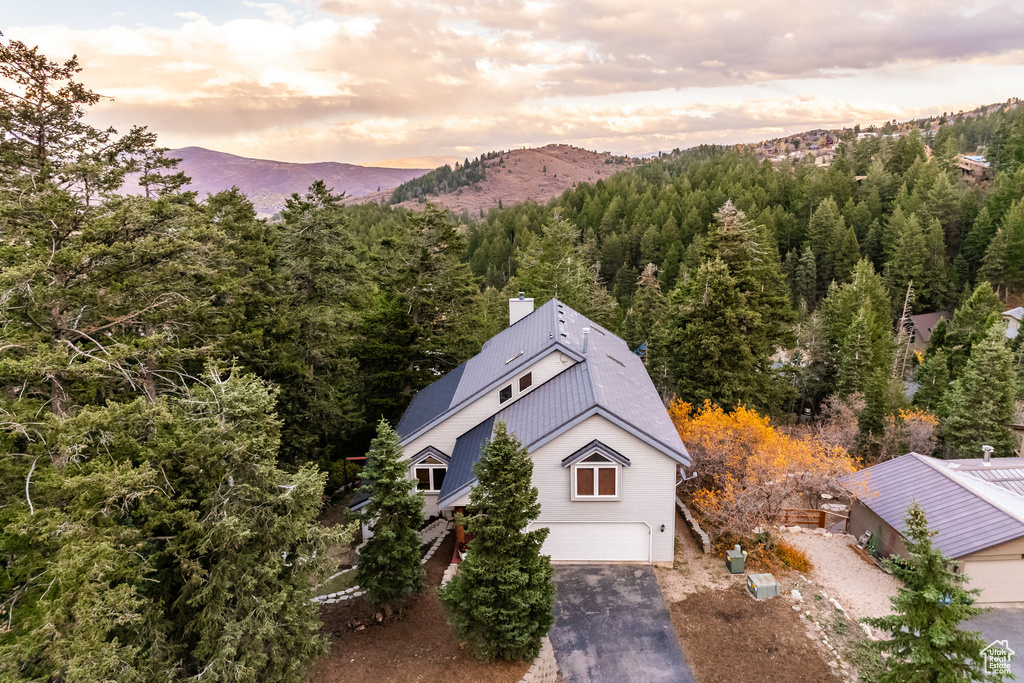 View from above of property with mountains and a forest