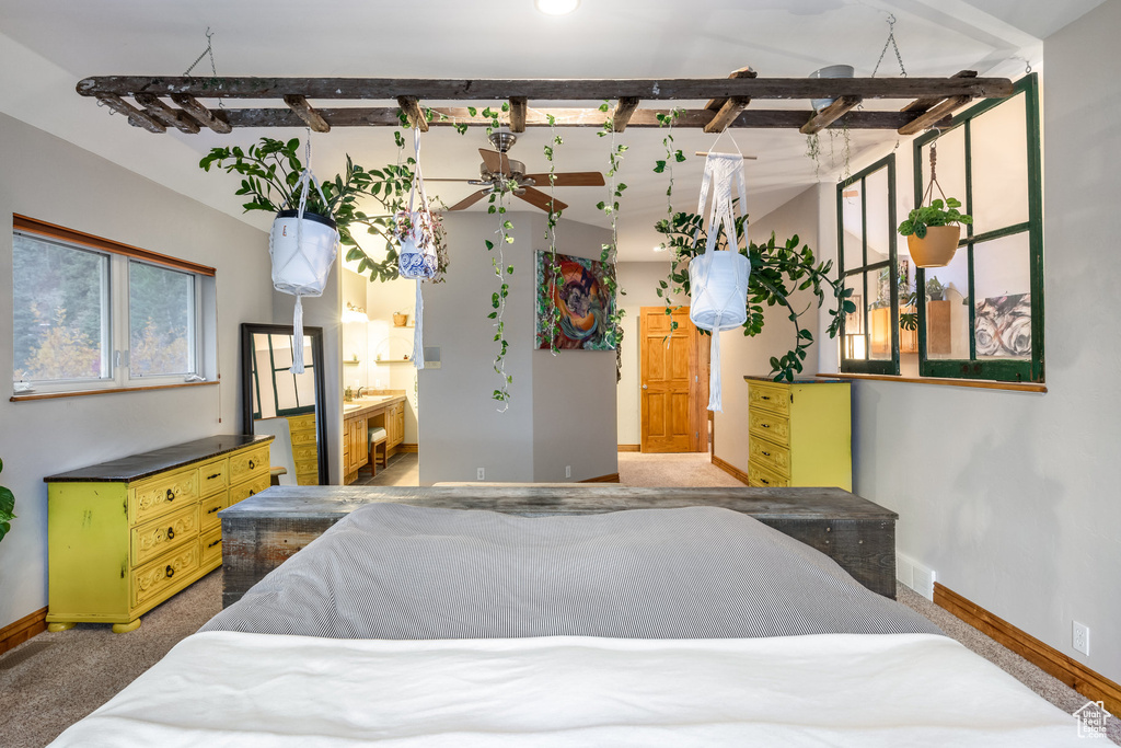 Bedroom with beamed ceiling and carpet