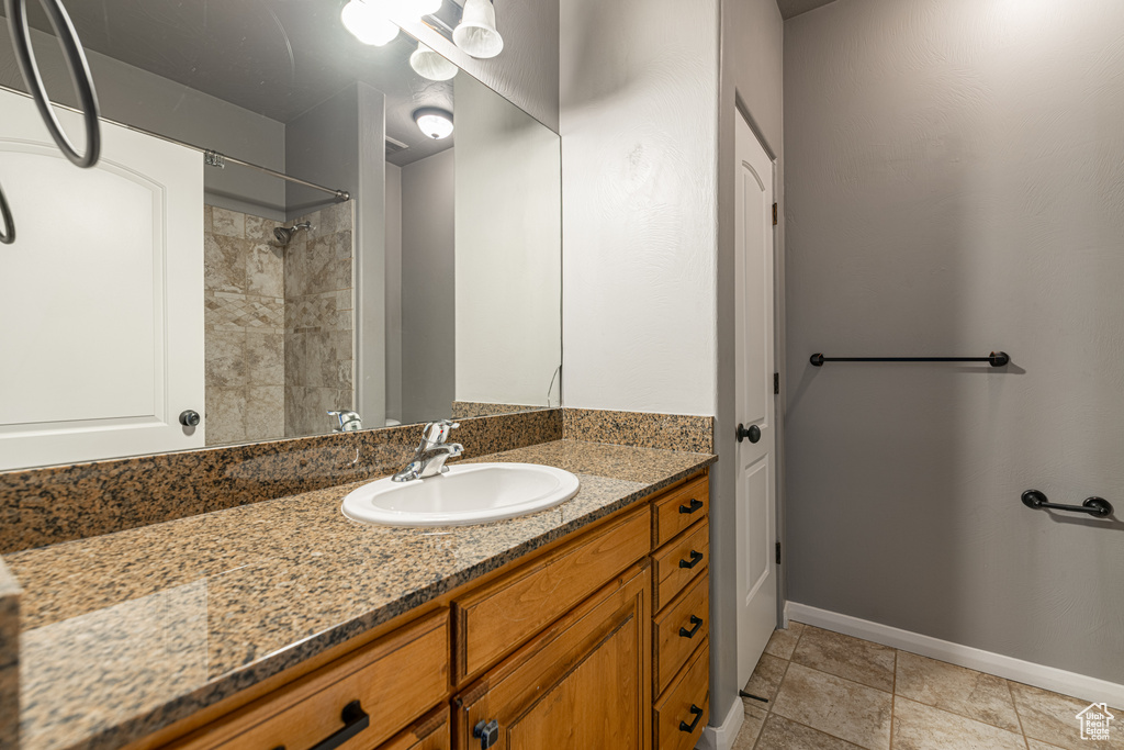 Bathroom with vanity and a tile shower