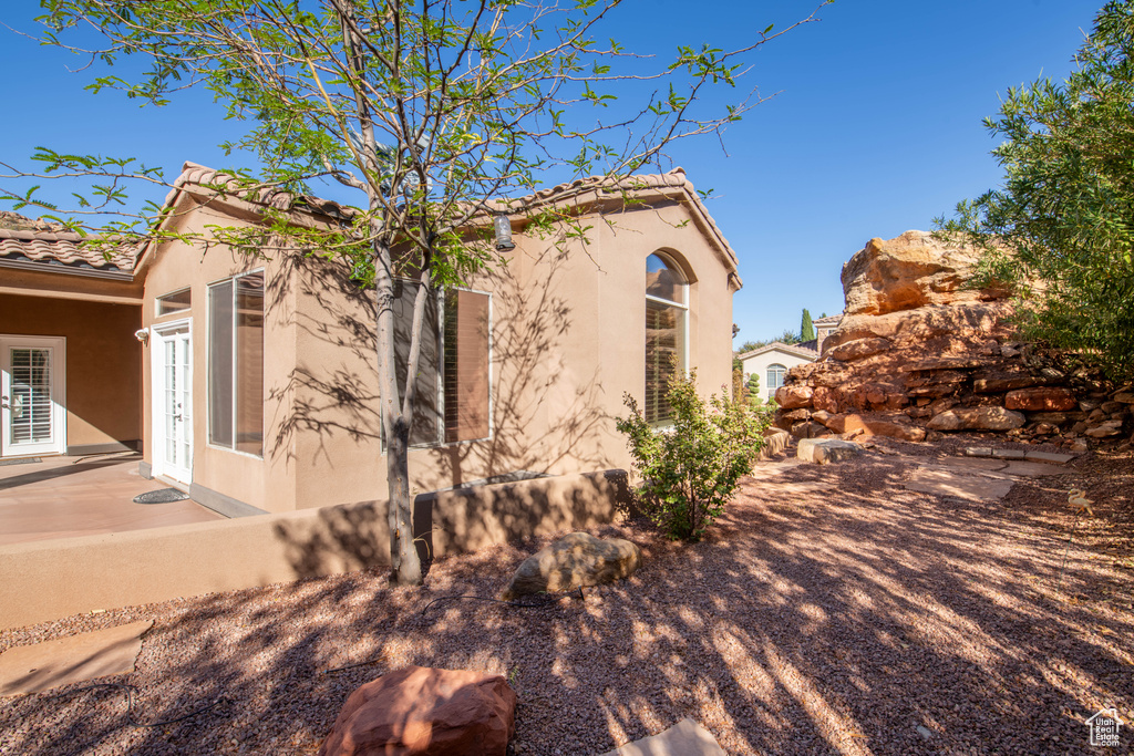 View of side of property with a patio