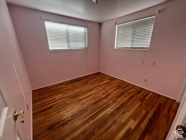 Spare room with hardwood / wood-style flooring