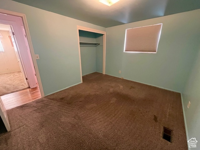 Unfurnished bedroom featuring carpet floors and a closet