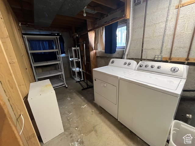 Clothes washing area featuring washer and dryer