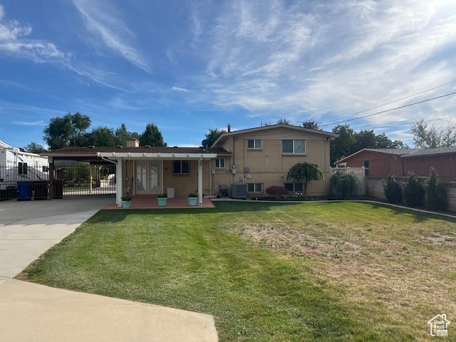 Back of house featuring a lawn