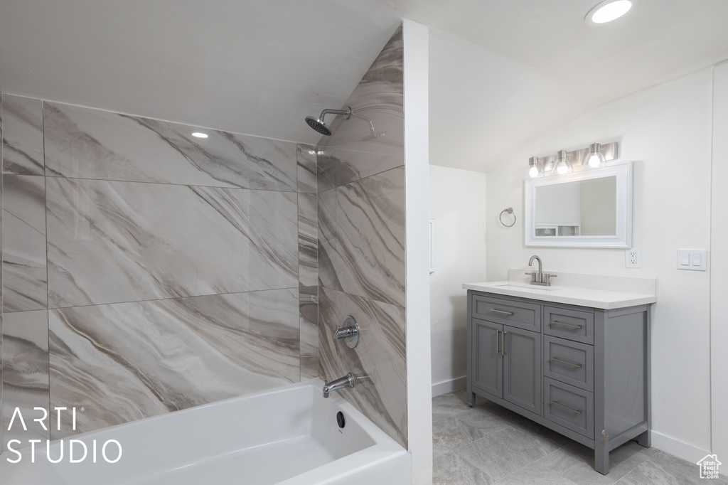 Bathroom featuring vanity and tiled shower / bath combo