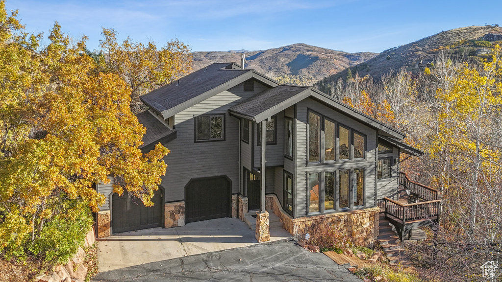 View of front of property with a mountain view and a garage