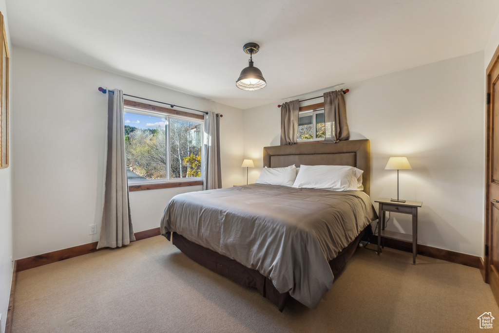 Bedroom featuring light carpet