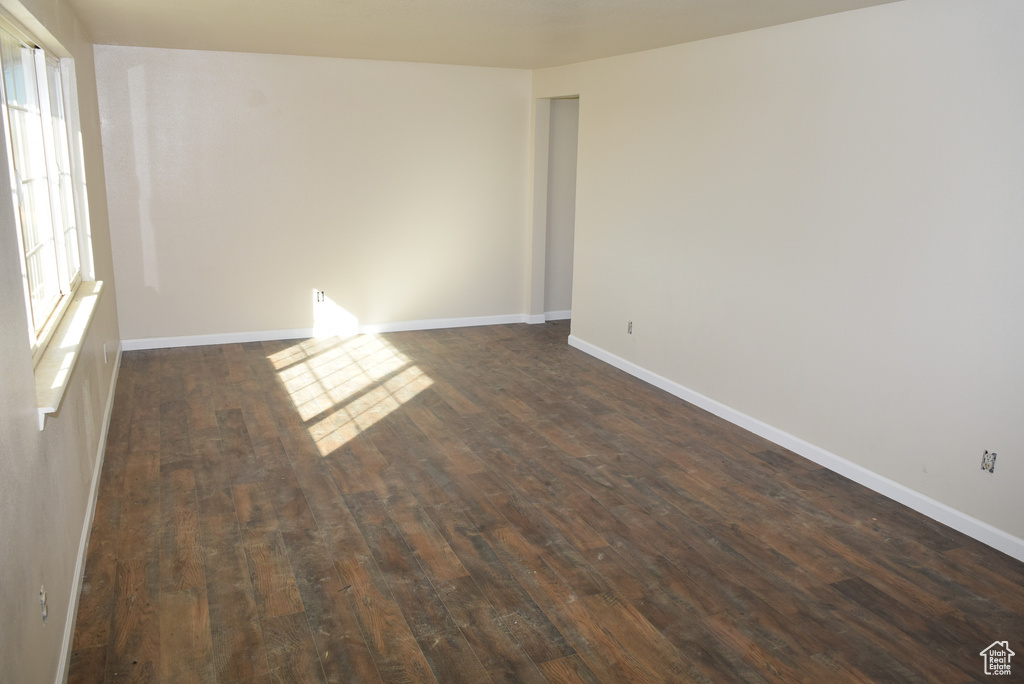 Unfurnished room featuring dark hardwood / wood-style flooring