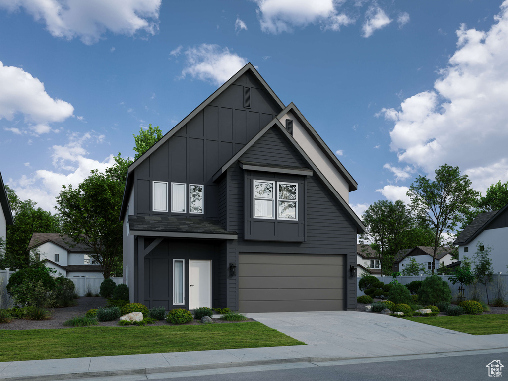 View of front of home with a front lawn and a garage