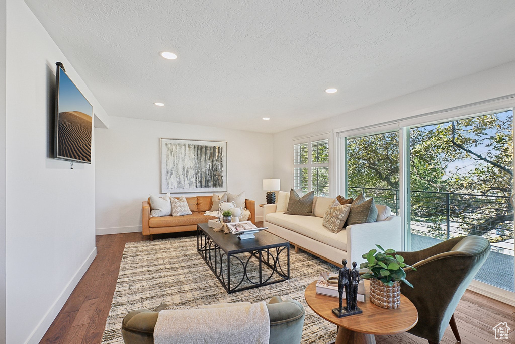 Living room featuring hardwood / wood-style floors and a textured ceiling