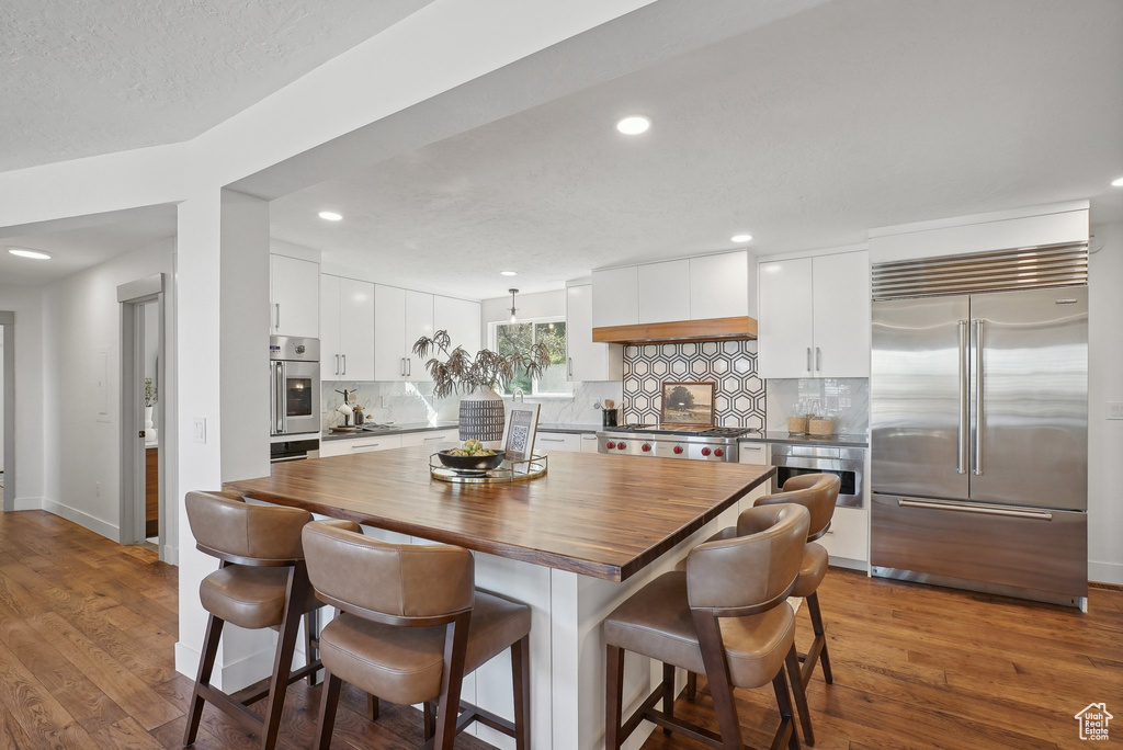 Dining area with a textured ceiling and dark hardwood / wood-style floors