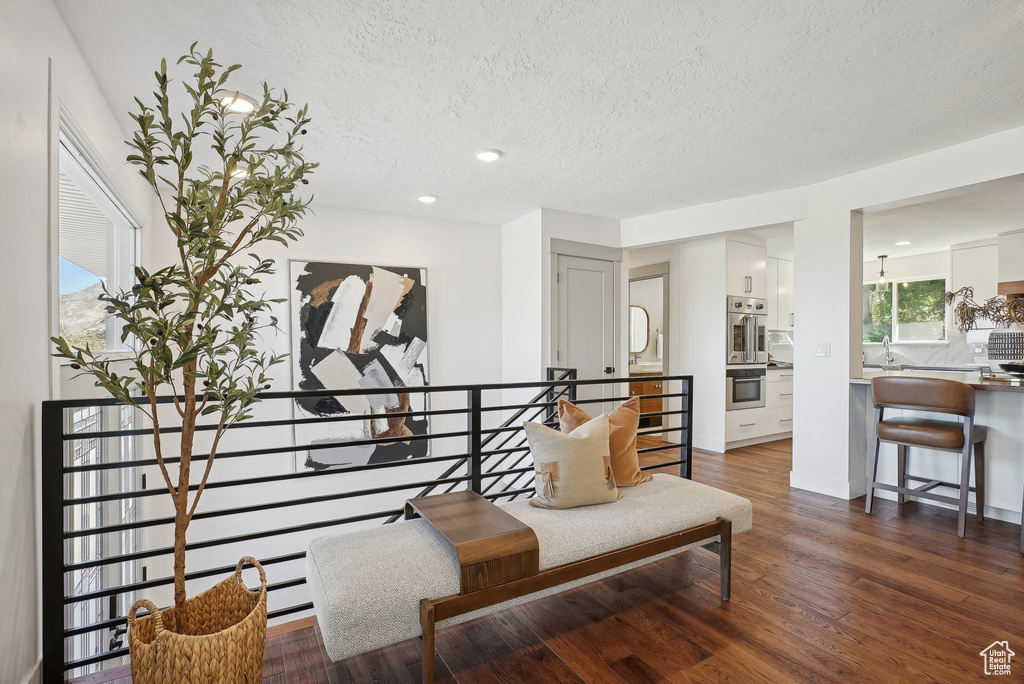 Living area featuring a textured ceiling and dark hardwood / wood-style floors