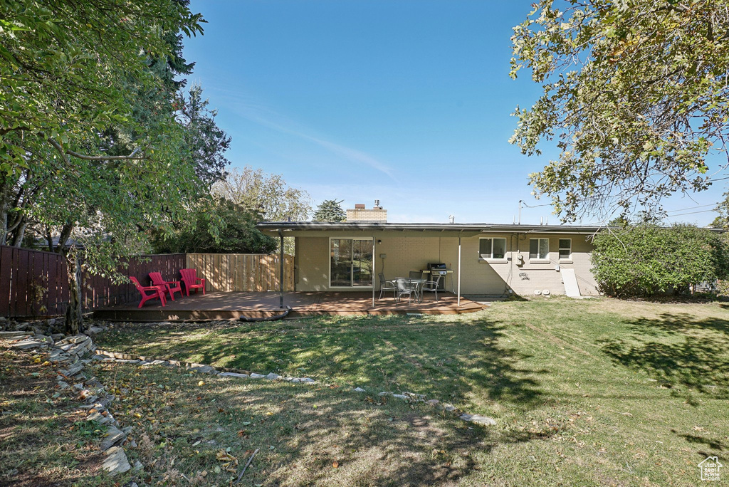 Back of house with a yard, a patio area, and a deck