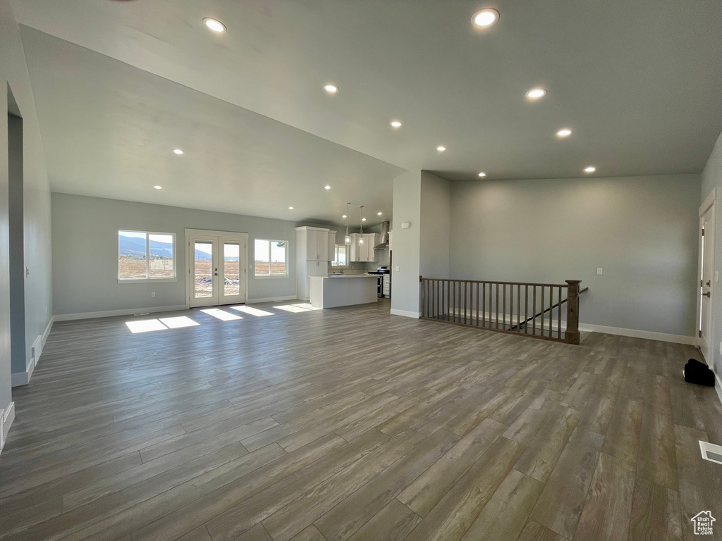 Unfurnished living room with french doors and hardwood / wood-style flooring