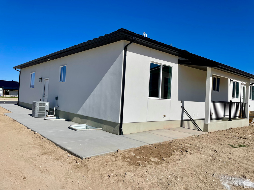 View of side of property featuring central AC