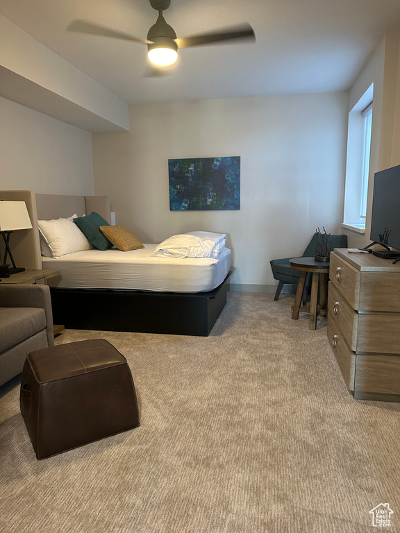 Bedroom with light carpet and ceiling fan