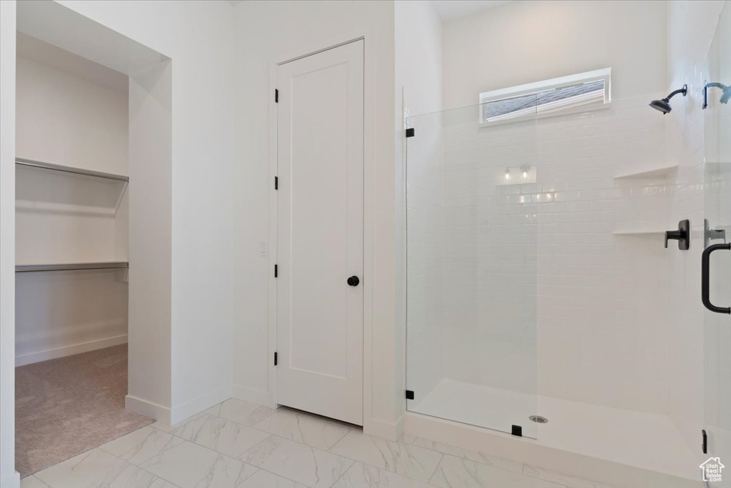 Bathroom featuring a shower with door