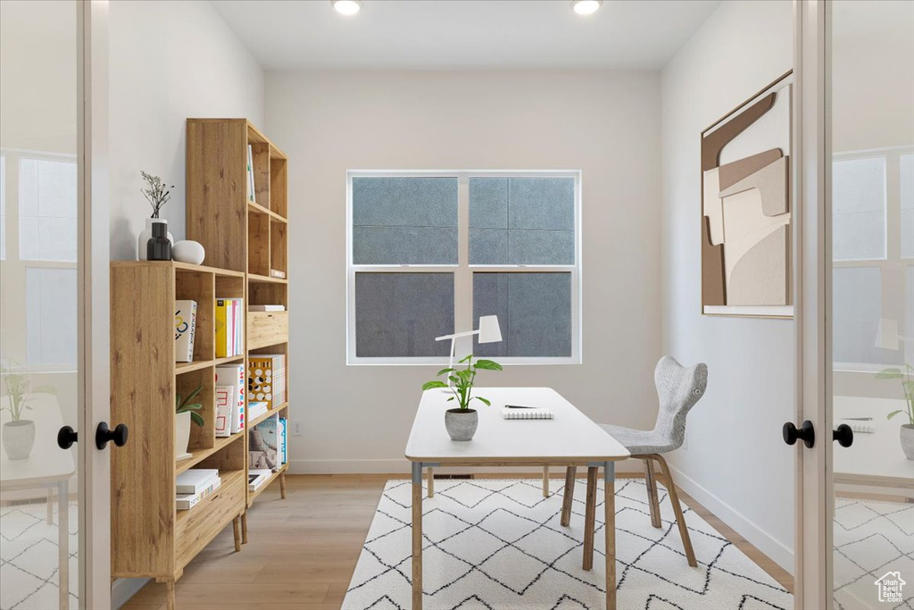 Office space featuring french doors and light wood-type flooring