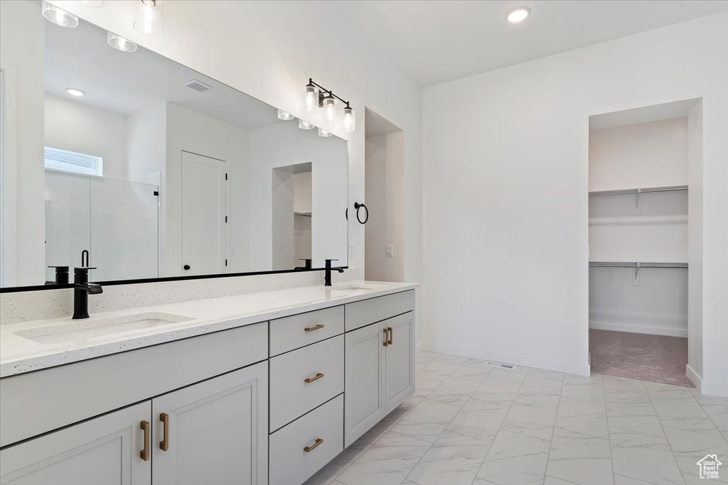 Bathroom featuring vanity and an enclosed shower