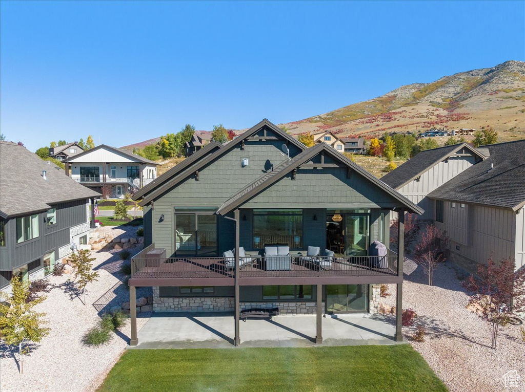 Rear view of house with a mountain view and covered porch