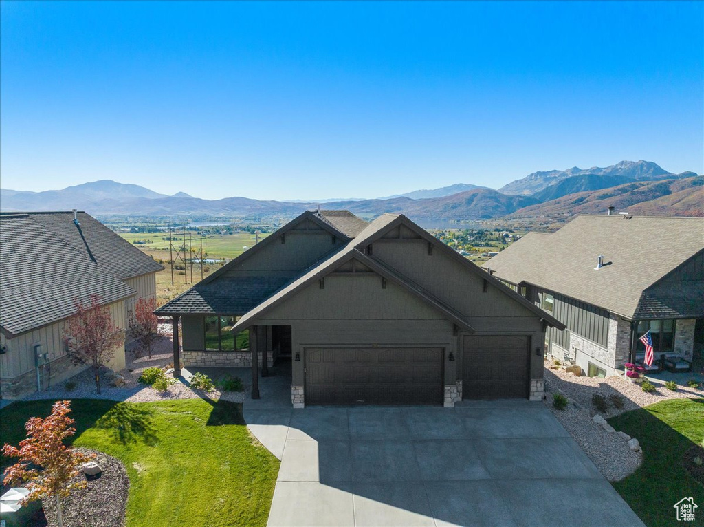 View of front facade with a garage and a mountain view