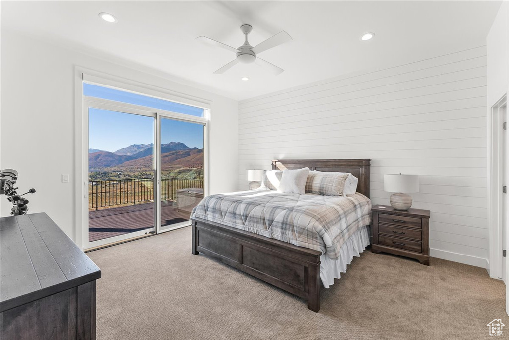 Carpeted bedroom featuring a mountain view, access to outside, and ceiling fan