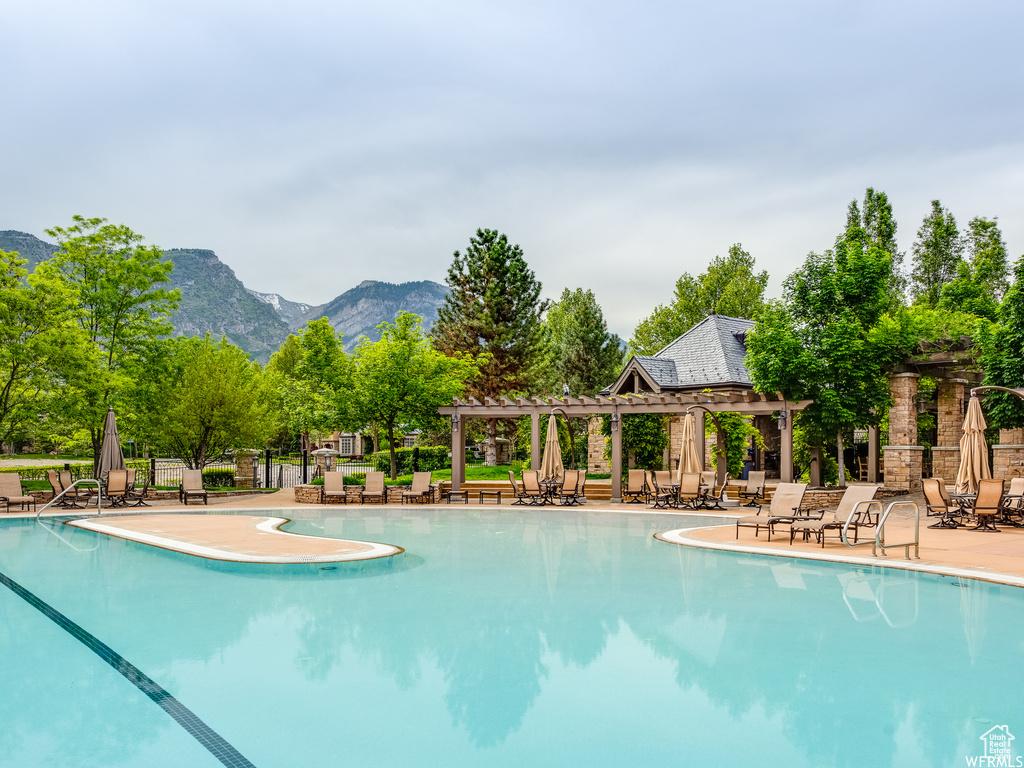 View of pool featuring a mountain view and a patio