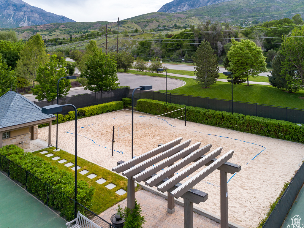 View of community featuring a mountain view and volleyball court