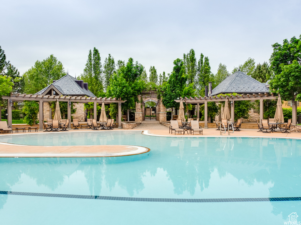 View of swimming pool featuring a patio and a pergola