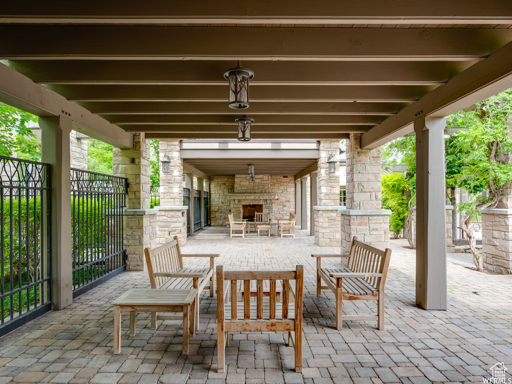 View of patio / terrace featuring an outdoor stone fireplace