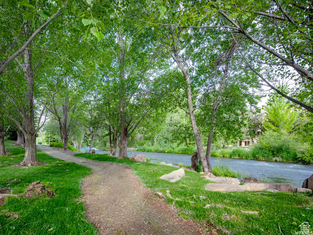 Surrounding community featuring a yard and a water view