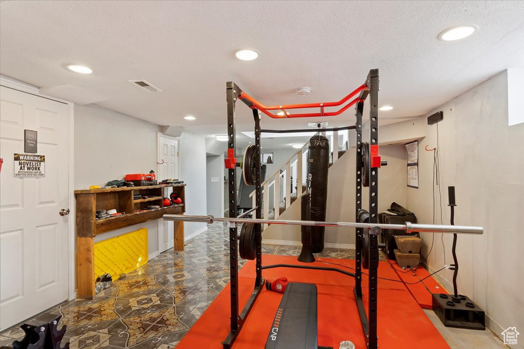 Exercise room featuring a textured ceiling