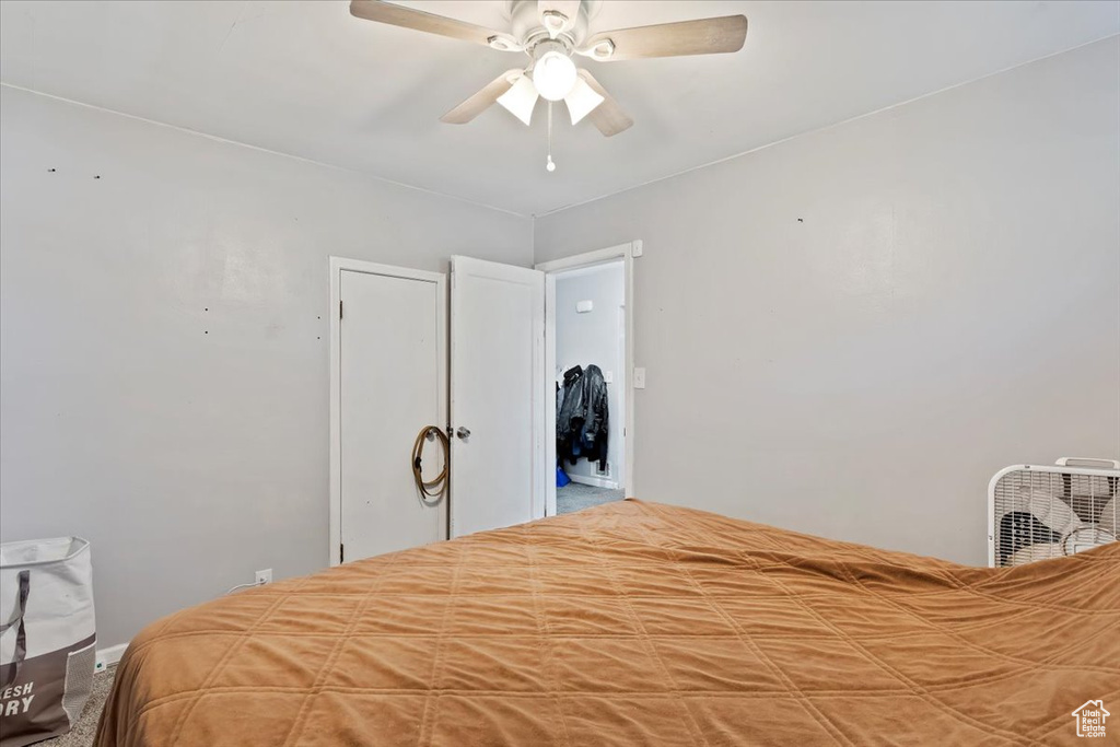 Carpeted bedroom featuring ceiling fan