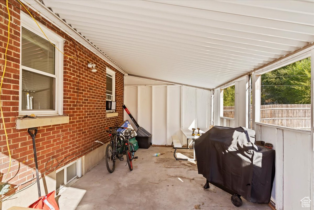 View of patio with a grill