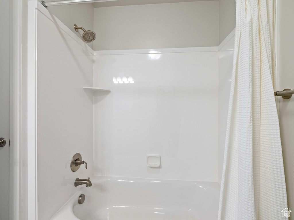 Bathroom featuring shower / bathtub combination with curtain