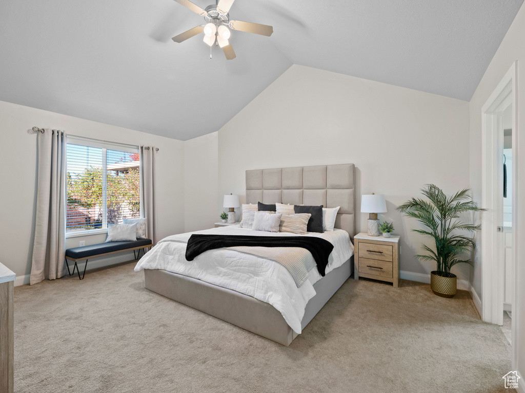 Carpeted bedroom featuring lofted ceiling and ceiling fan