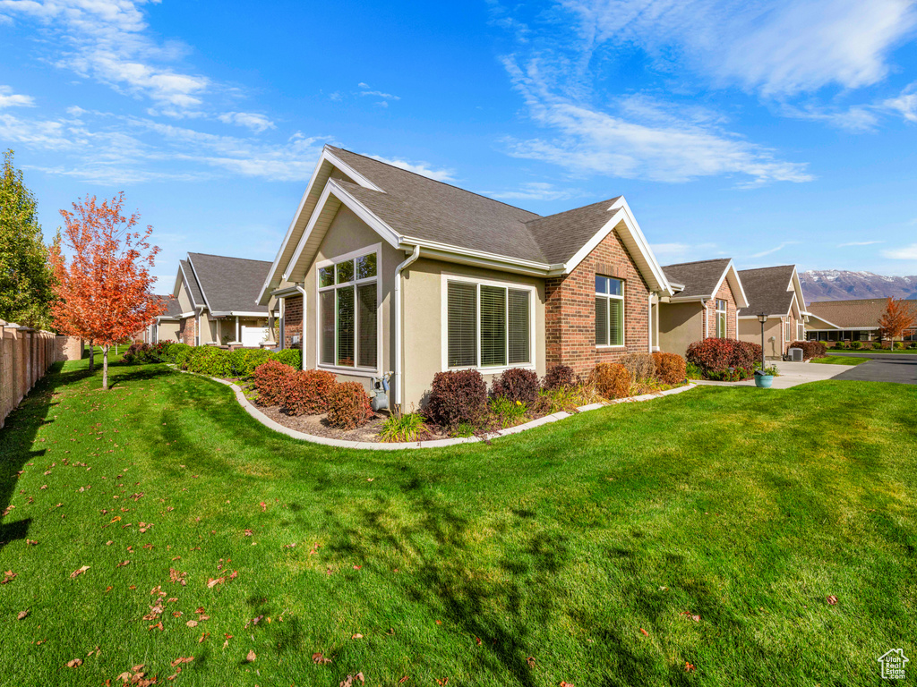 View of home's exterior with a yard