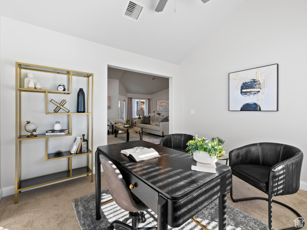 Dining area featuring lofted ceiling, carpet floors, and ceiling fan