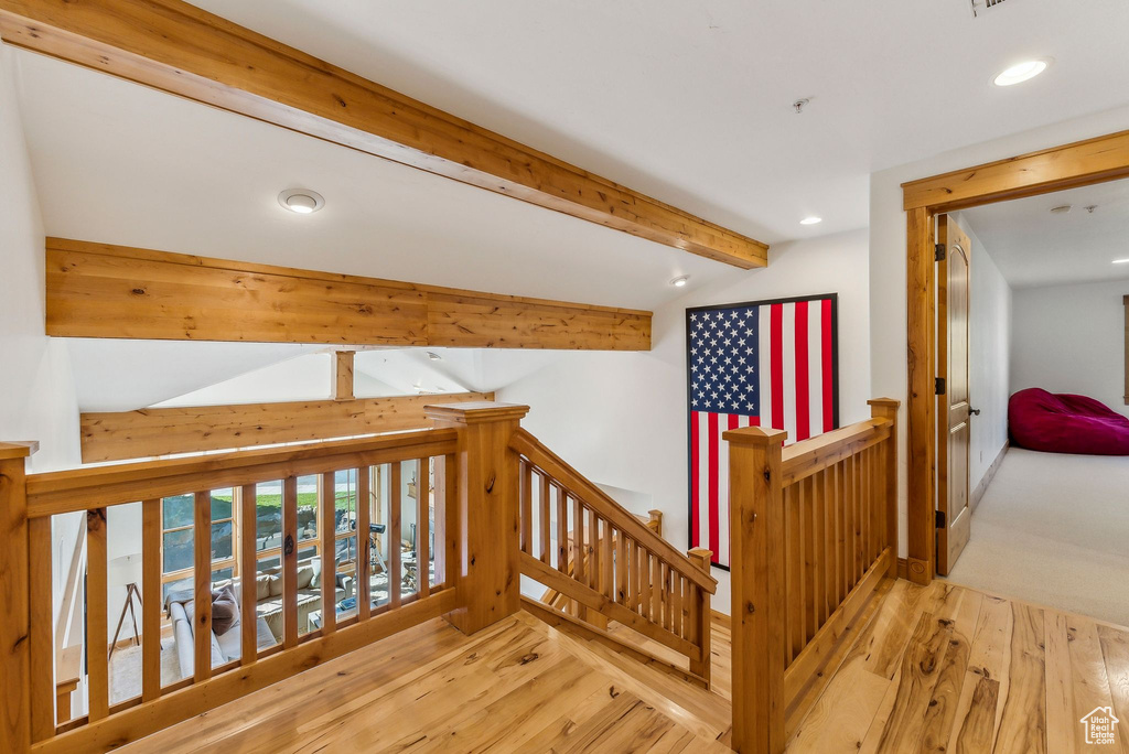 Hall featuring hardwood / wood-style floors and beam ceiling