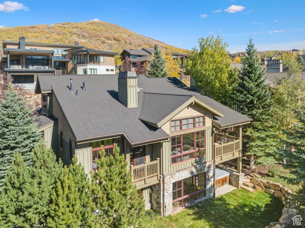 Rear view of property featuring a mountain view and a balcony