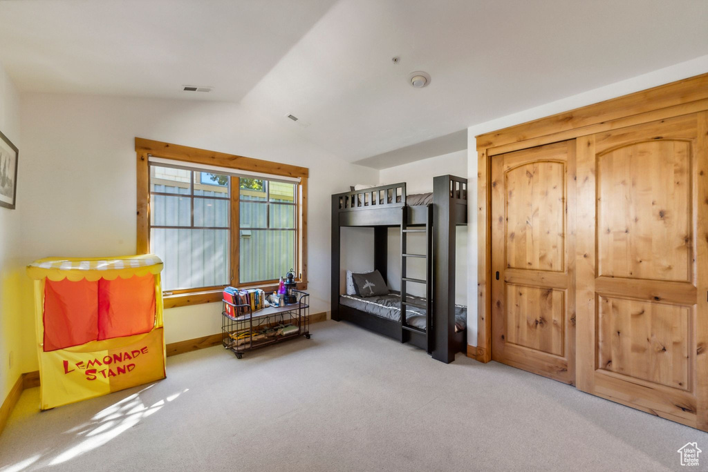 Sitting room featuring vaulted ceiling and carpet floors