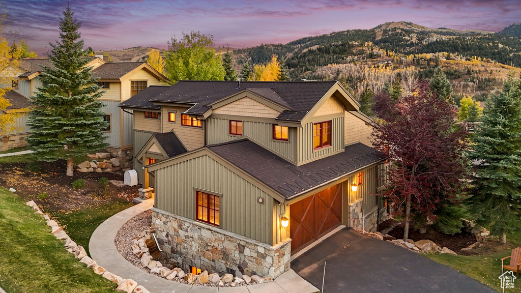 View of front of house featuring a mountain view and a garage