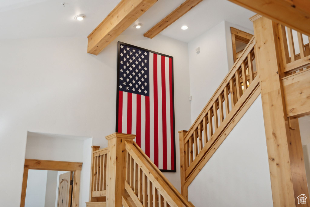 Staircase featuring beam ceiling